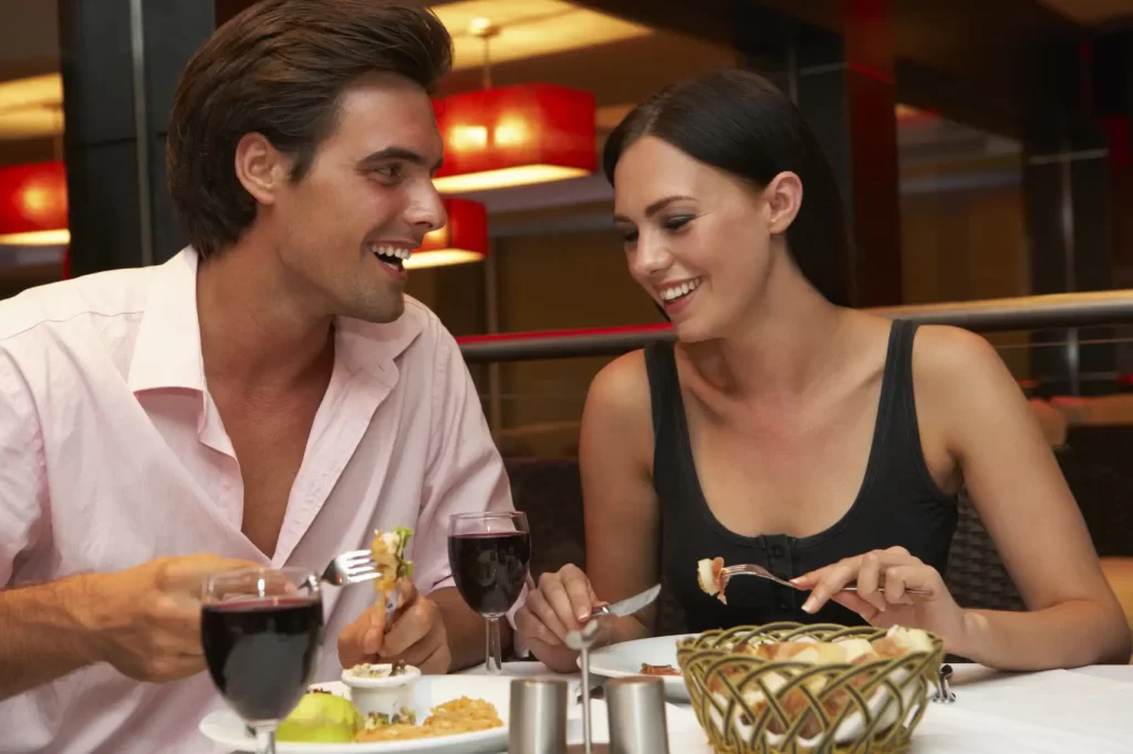 A couple eating at a fine restaurant.