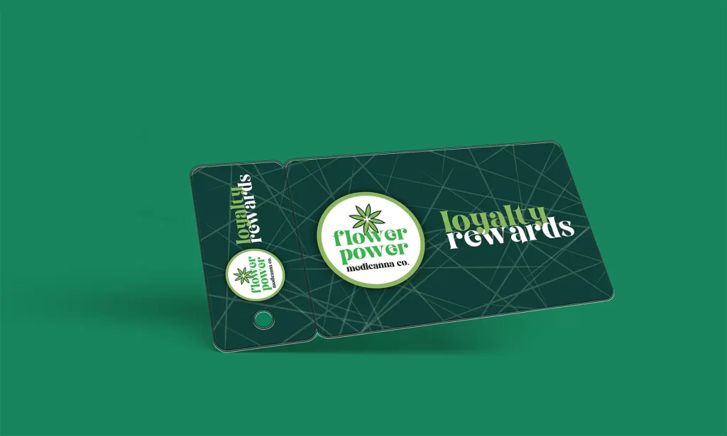 Dispensary loyalty rewards card and key tag on a green background