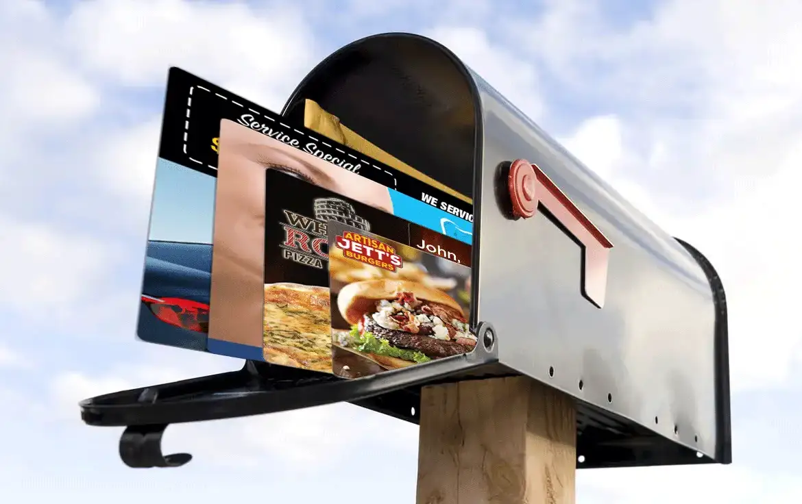 Mailbox full of AcclaimMailer™ direct mail plastic postcards sky in the background