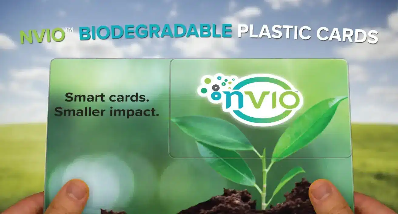 Person holding NVIO™ biodegradable eco-friendly plastic postcard.